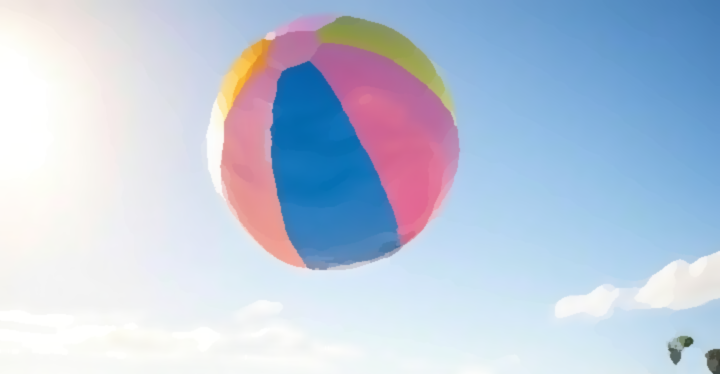 A colorful beach ball flying in the air